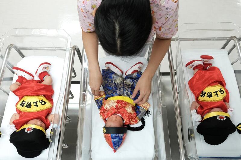 A nurse checks in on newborns wearing Chinese traditional costumes to celebrate the Chinese New Year at the nursery of Paolo Chockchai 4 Hospital, in Bangkok, Thailand on January 27, 2017. Athit Perawongmetha / Reuters