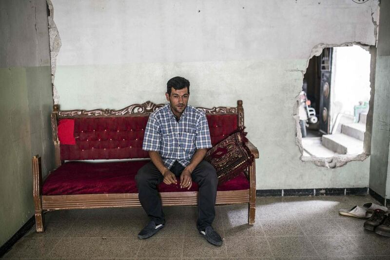 Abdullah Kurdi, the father of three-year-old Alan, sits in a relative’s house in Kobani, Syria, on September 6, 2015. Yasin Akgul / AFP 