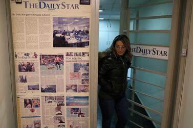 FILE - An employee of The Daily Star newspaper opens the main door of the newspaper office, in Beirut, Lebanon, Tuesday, Feb.  4, 2020.  Lebanon's Daily Star newspaper, one of the leading English-language newspapers in the Arab world and Lebanon's oldest, has folded following a years-long financial struggle.  Employees were formally informed of the decision to lay off all staff as of October 31 in an email sent to staff earlier this week and seen by The Associated Press Tuesday, Nov.  2, 2021.  (AP Photo / Hussein Malla)