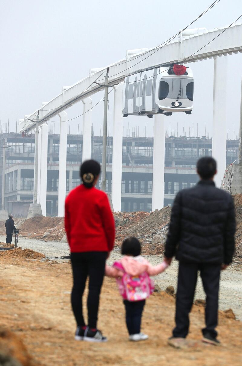 Mandatory Credit: Photo by Xinhua/Shutterstock (7450143h)
Locals watch a train suspended from a railway line running in Chengdu, capital of southwest China's Sichuan Province
Suspension railway line, Chengdu, Sichuan Province, China - 21 Nov 2016
After two months of tests, China's first suspension railway line met all designed requirements and it is ready for more systematic operations.