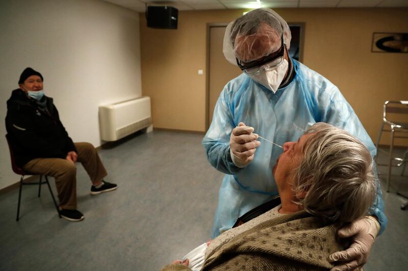 A medical worker takes nasal swab samples at a test station for Covid-19 in Beziers, France. EPA