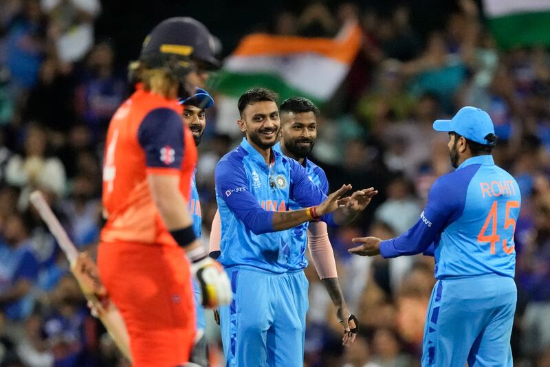 India's Axar Patel, centre, is congratulated by teammates after bowling Netherlands' Max O'Dowd. AP