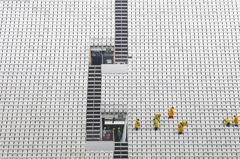 Workers clean the bleachers of the unfinished Arena Corinthians stadium, in Sao Paulo, Brazil. The Fifa World Cup 2014 will begin on 12 June. Diego Azubel / EPA