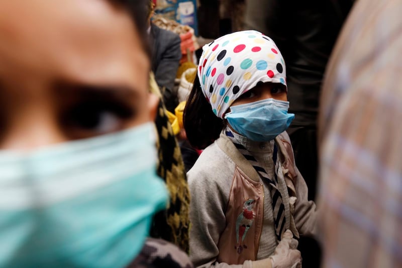 A child wearing a protective face mask as she walks through a market in Sanaa, Yemen on May 20, 2020. EPA