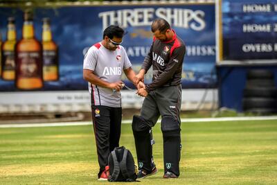 UAE's captain Rohan Mustafa receives treatment for his finger injury during the World Cricket League Division 2 match in Namibia against Canada. Image courtesy of Johan Jooste.