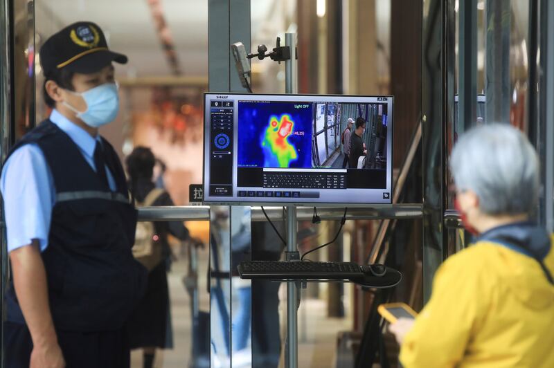 A thermal camera detects the body temperature of a customer as a measure to prevent the spread of the coronavirus disease (COVID-19) at an entrance of a restaurant, in Taipei, Taiwan, November 30, 2021. Reuters