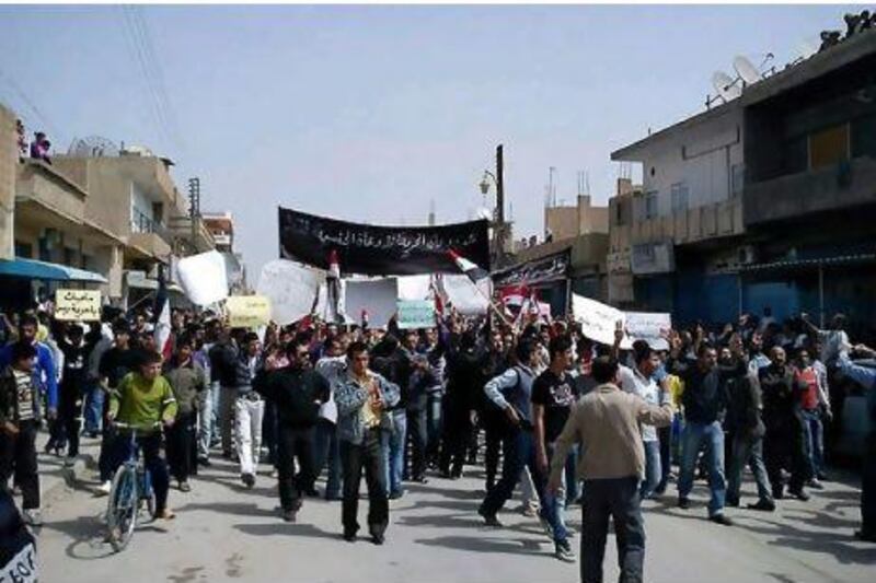 Syrian anti-government protesters march in the town of Qamishli in the first rallies since President Bashar al Assad dashed hopes for greater freedoms.
