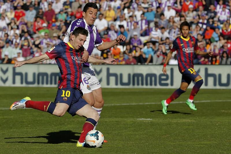 Barcelona’s Argentinian forward Lionel Mess, left, kicks the ball past Valladolid’s defender Jesus Rueda during the Spanish league football match Real Valladolid FC vs FC Barcelona at Jose Zorilla stadium in Valladolid on March 8, 2014. Cesar Manso / AFP
