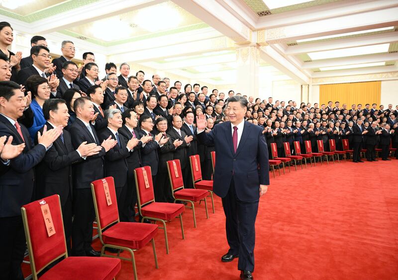 President Xi Jinping waves to attendees at an annual conference for Chinese overseas envoys, at the Great Hall of the People in Beijing. EPA