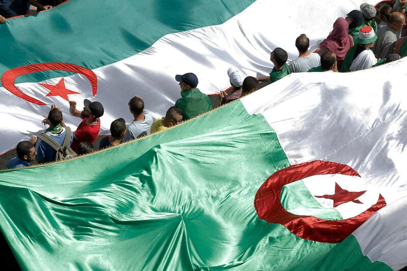 Algerian protesters gather during an anti-government demonstration in the center of the capital Algiers, Algeria, Friday, June 14, 2019.  Algeria is in the midst of an unprecedented anti-corruption crusade, sparked by a people's revolt in February and prompting many lawmakers to be questioned over allegations, and former Algerian prime minister Abdelmalek Sellal jailed Thursday in an anti-corruption sweep.(AP Photo/Fateh Guidoum)