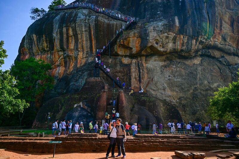 Foreign tourists visit the ancient rock fortress in Sigiriya on February 18, 2024.  (Photo by Ishara S.  KODIKARA  /  AFP)