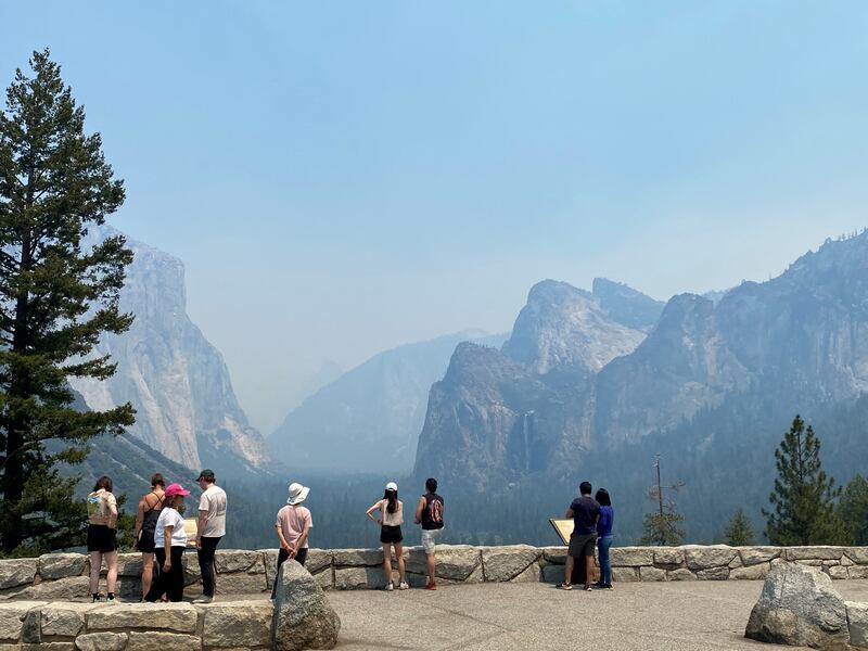 Visitors view the Yosemite landscape through a haze from the Washburn fire. Reuters