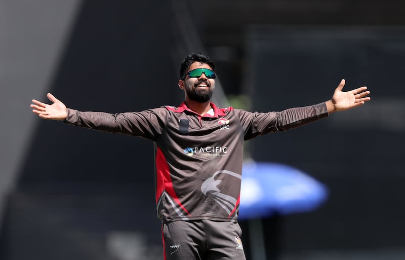 The UAE's Basil Hameed celebrates taking the wicket of Papua New Guinea's Hiri Hiri in the ICC World Cup League 2 match at the Sharjah Cricket Stadium on Tuesday, March 15, 2022. All images Chris Whiteoak / The National