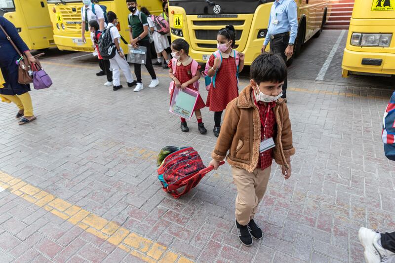 Children arrive at the Delhi Private School for the first day of the new term.