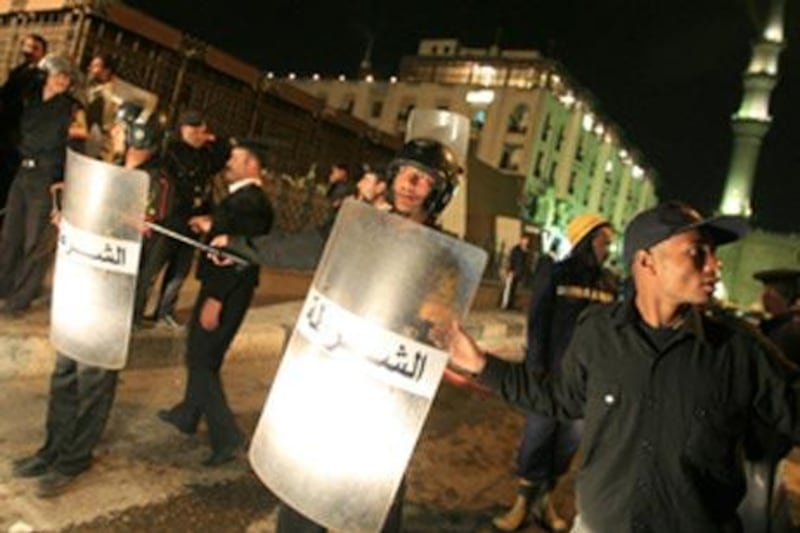 Egyptian policemen block the way leading to the site of the explosion in Cairo.