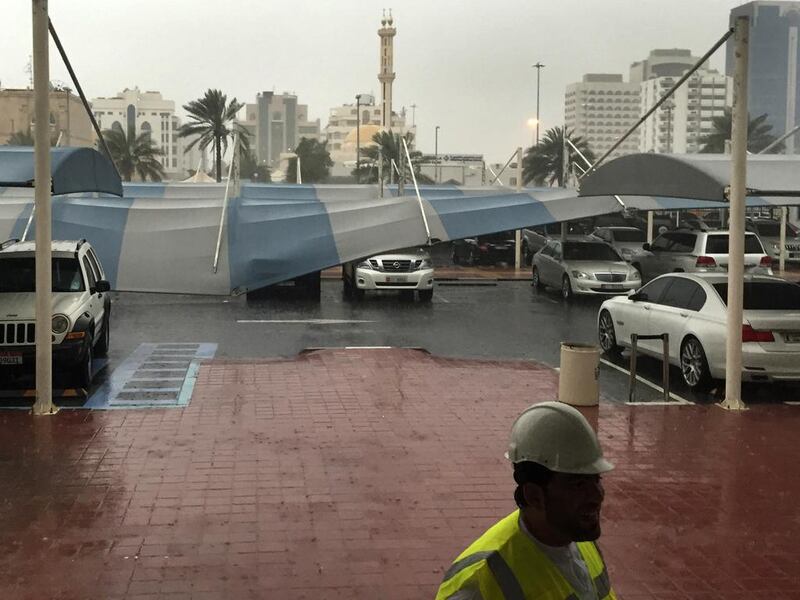 Car shades at Abu Dhabi Media blown down by heavy winds and rains. Mohammed Al Otaiba / The National