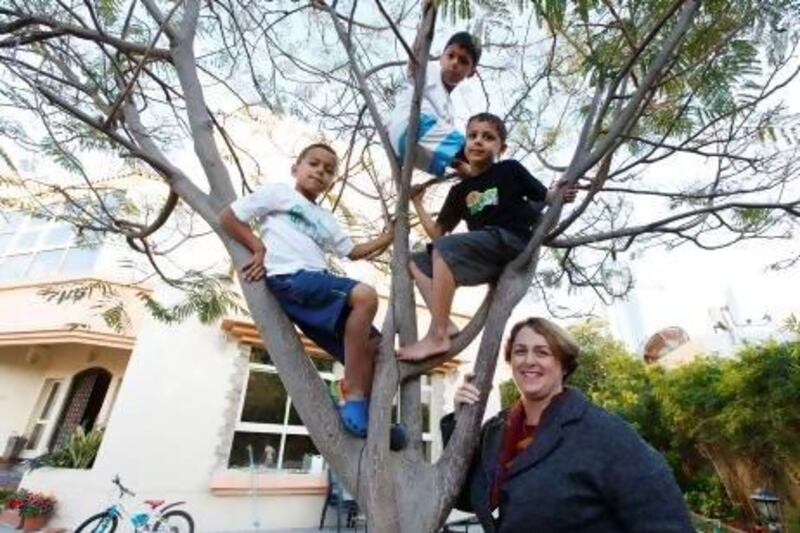 Therese Sequeira at home in Dubai with her children Anton, Simeon and Dominic. Sarah Dea / The National