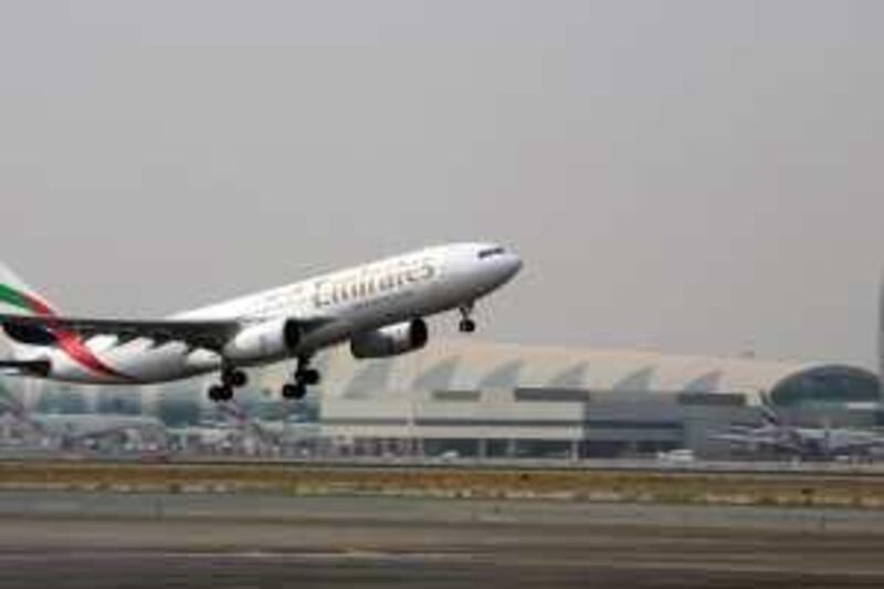 DUBAI, UNITED ARAB EMIRATES - AUGUST 9:  An Emirates plane takes off from Terminal 2 of the Dubai International airport in Dubai on August 9, 2009.  (Randi Sokoloff / The National)  For Stock. *** Local Caption ***  RS008-080909-EMIRATES.jpg