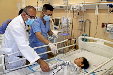 Dr Marwan Abu Sada attends to a wounded child at at Shifa Hospital in Gaza city on May 17, 2021. Reuters