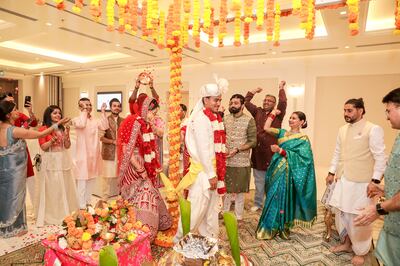 Family and friends shower the couple with flowers and rice as part of the wedding ceremony at the Hindu temple in Dubai. Photo: Suraj Negi