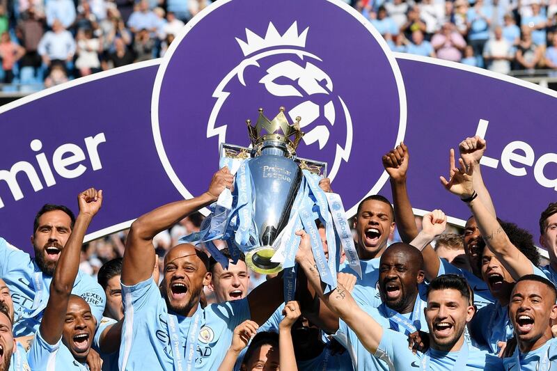 Vincent Kompany of Manchester City lifts the Premier League Trophy as Manchester City celebrate winning the Premier League after the Premier League match between Manchester City and Huddersfield Town at Etihad Stadium in Manchester, England, on May 6, 2018. Shaun Botterill / Getty Images
