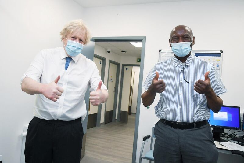 Boris Johnson gives thumbs up with Silvester Biyibi during the visit. Reuters