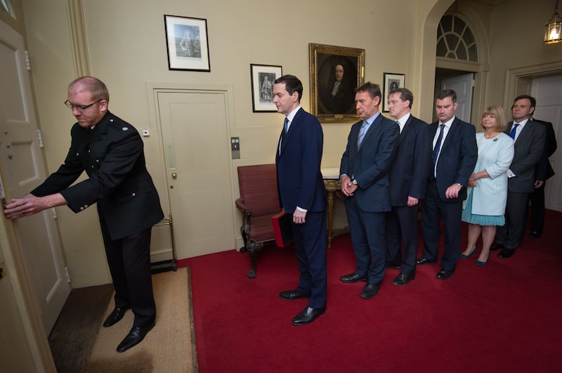 George Osborne leads his Treasury team out of 11 Downing Street to deliver the first Budget of the new Conservative government in 2015