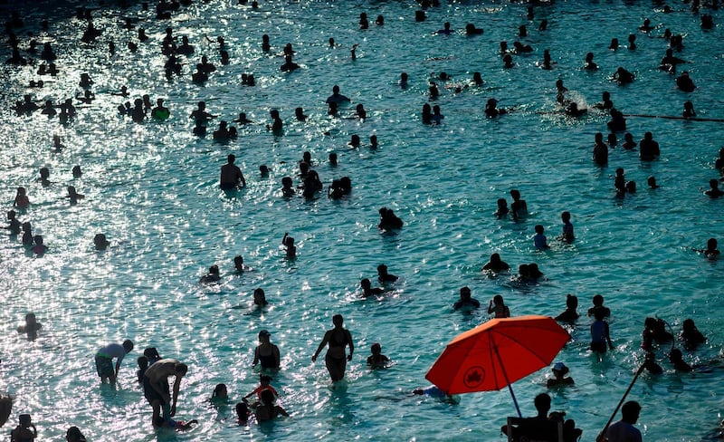 People enjoy the Astoria Pool on a hot afternoon in the borough of Queens, New York City, on July 20, 2019.   The US is sweating through a weekend of extremely hot weather, with major cities including New York and Washington bracing for temperatures close to or exceeding 100 degrees Fahrenheit (38 degrees Celsius). Nearly 150 million people across the country are facing hazardous temperatures in a heatwave stretching from the Midwestern plains to the Atlantic coast, the National Weather Service said. / AFP / Johannes EISELE
