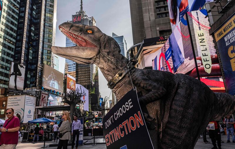 Frankie the Dinosaur, mascot of the United Nations development programme 'Don’t Choose Extinction' visits Times Square spreading his climate-related message in New York. AFP