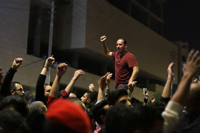 A protester leads the crowd to co-ordinate their anti-government chanting. Andre Pain / EPA