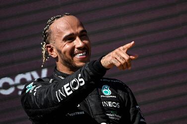 (FILES) In this file photo taken on July 24, 2022, Mercedes' British driver Lewis Hamilton celebrates on the podium of the French Formula One Grand Prix at the Circuit Paul-Ricard in Le Castellet, southern France.  - Seven-time Formula One world champion Lewis Hamilton has joined the ownership group of the NFL's Denver Broncos, the team announced on August 2, 2022.  (Photo by CHRISTOPHE SIMON  /  AFP)