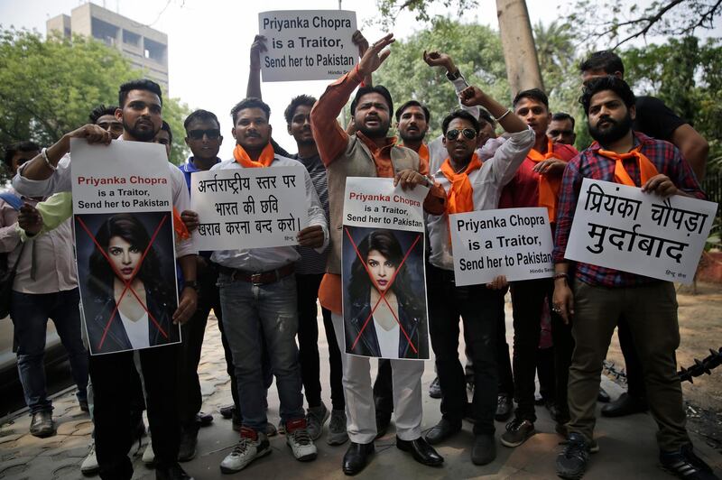 Activists of ultra right-wing Hindu Sena or Hindu Army hold posters featuring photographs of Indian actress Priyanka Chopra during a protest in New Delhi, India, Saturday, June 9, 2018. U.S. television studio ABC on Friday issued an apology after an episode of Quantico, which stars Chopra in a lead role, triggered outrage among its Indian audience. The plot of the episode showed Indian nationalists trying to frame Pakistan in a terror plot. The posters in Hindi, left, read "Stop damaging the image of India at international level" and right "Down with Priyanka Chopra". (AP Photo/Altaf Qadri)