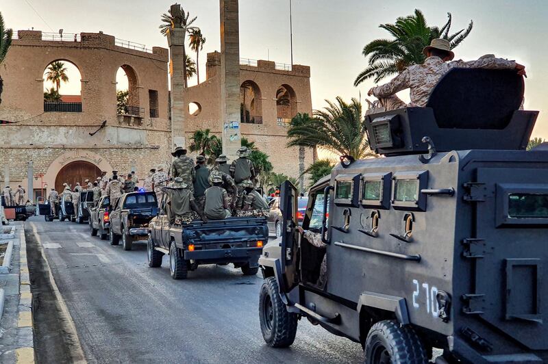 Vehicles of the "Tripoli Brigade", a militia loyal to the UN-recognised Government of National Accord (GNA), parade through the Martyrs' Square at the centre of the GNA-held Libyan capital Tripoli on July 10, 2020. (Photo by Mahmud TURKIA / AFP)