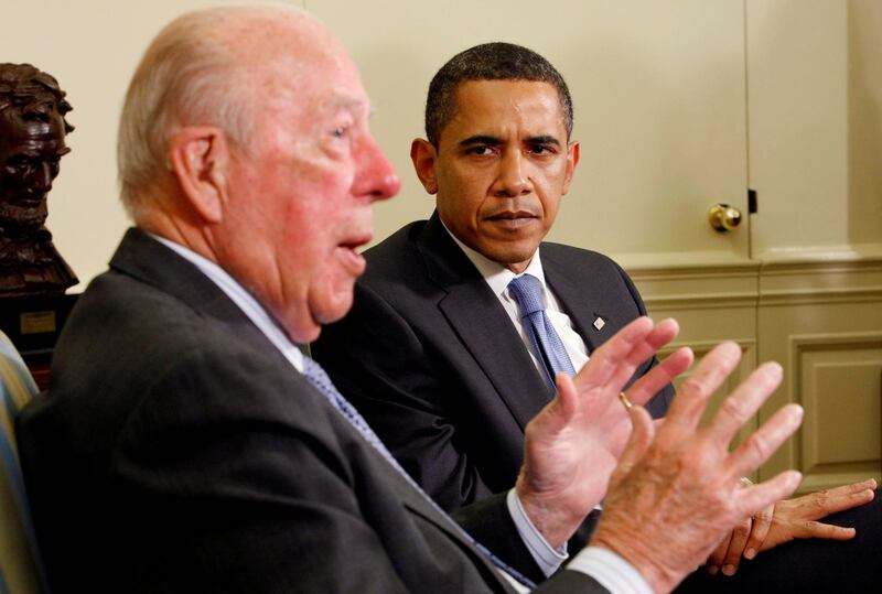 US President Barack Obama listens as former George Shultz speaks in the Oval Office of the White House on May 19, 2009. Reuters