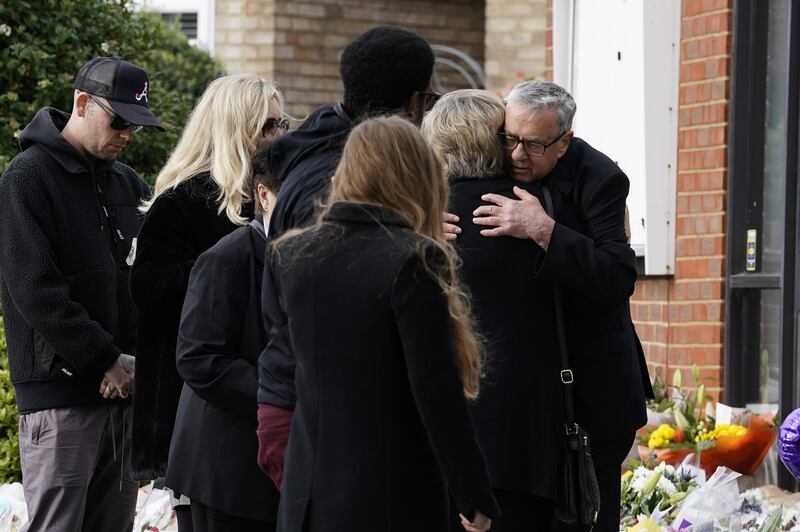 The Rev Clifford Newman of Belfairs Methodist Church hugs Sir David Amess's widow.  AP