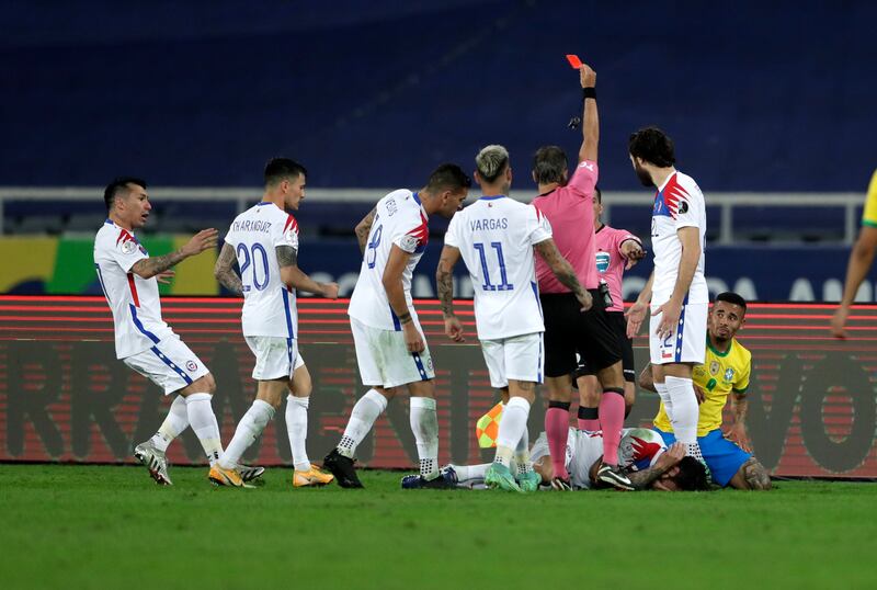 Referee Patricio Loustau shows the red card to Brazil's Gabriel Jesus.