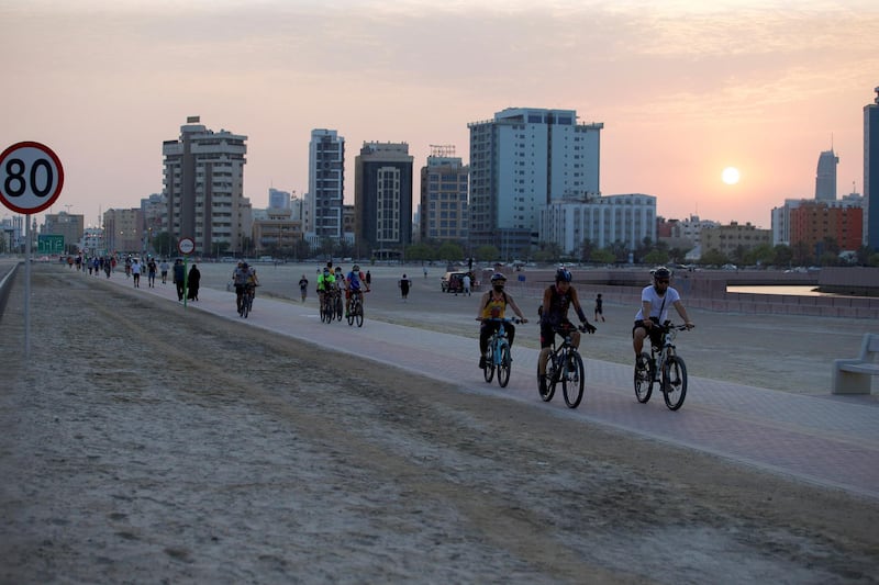 People ride their bikes during the sunset, following the coronavirus disease (COVID-19) outbreak, in Manama, Bahrain, July 14, 2020, REUTERS/Hamad I Mohammed