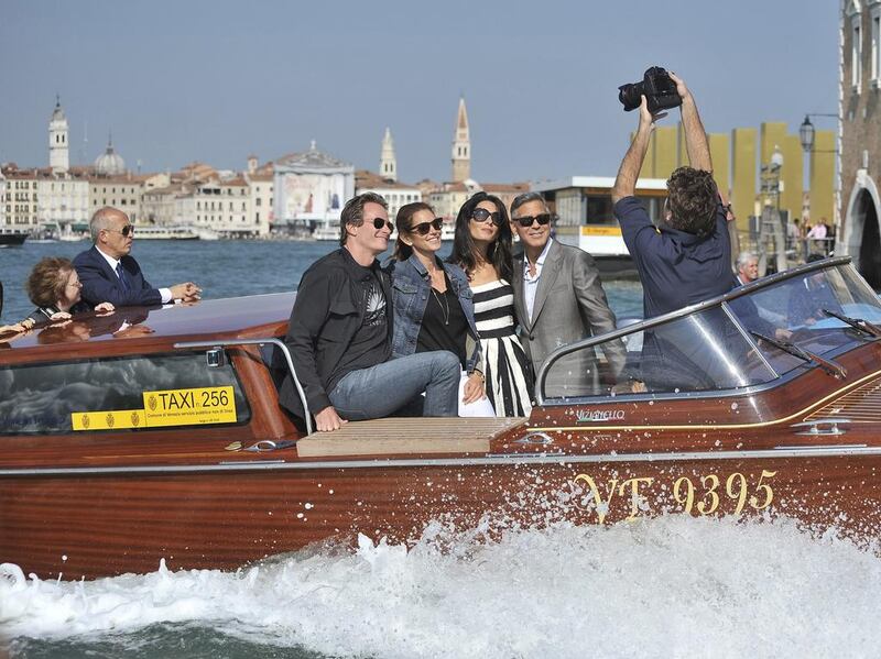 George Clooney with Amal, Cindy Crawford, and her husband Rande Gerber (left) as they cruise past St Mark’s Square in Venice. AP