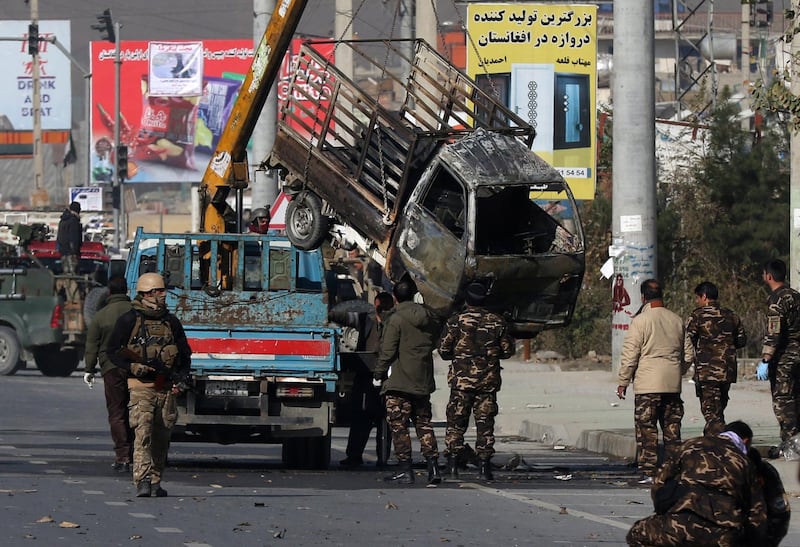 Security personnel inspect a damaged vehicle which was carrying and shooting rockets, in the aftermath of a rocket attack in Kabul, Afghanistan. According to media reports at least three people were killed and 11 others were injured as multiple rockets landed on the Afghann capital.  EPA