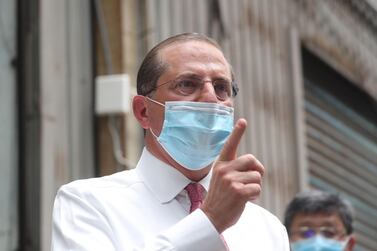 US Secretary of Health and Human Services Alex Azar gestures while visiting a mask factory in the Wugu district of New Taipei City on August 12, 2020. Azar is in Taipei for a three-day visit. / AFP / POOL / Pei Chen