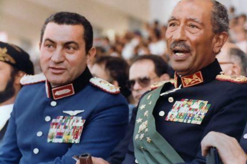 vice President at the time, Hosni Mubarak (left) and late president Anwar Sadat, attend a military parade on October 6, 1981, in Cairo during which the latter was assassinated. AFP Photo