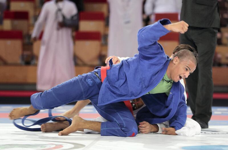 ABU DHABI,  UNITED ARAB EMIRATES , April 22 – 2019 :- Hazza Alqubaisi ( red from Al Wahda Club Jiu Jitsu Academy ) celebrating after beating Artur Osipov ( blue from Checkmat International Checkmat ) during the final of male 73kg category in  the Abu Dhabi World Professional Jiu Jitsu  Championship 2019 held at the Mubadala Arena in Abu Dhabi. ( Pawan Singh / The National ) For Sports. Story by Amith