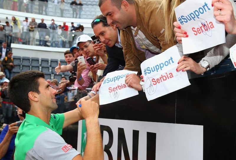 Novak Djokovic signs autographs in support of his native Serbia after defeating Rafael Nadal of Spain in the final of the Rome Masters on May 18, 2014. Julian Finney / Getty Images