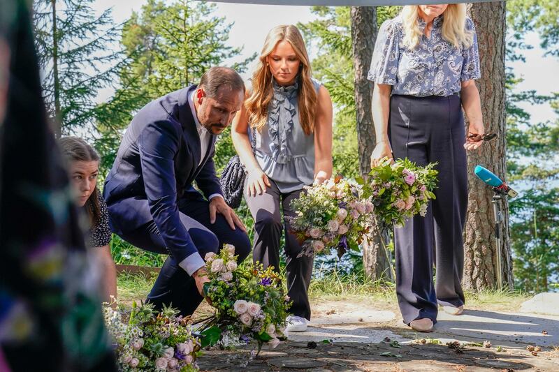 Crown Prince Haakon (2nd L) and Princess Ingrid Alexandra  (3rd L) lay flowers, 10 years after the right-wing extremist killed 77 people in a terrorist attack. AP