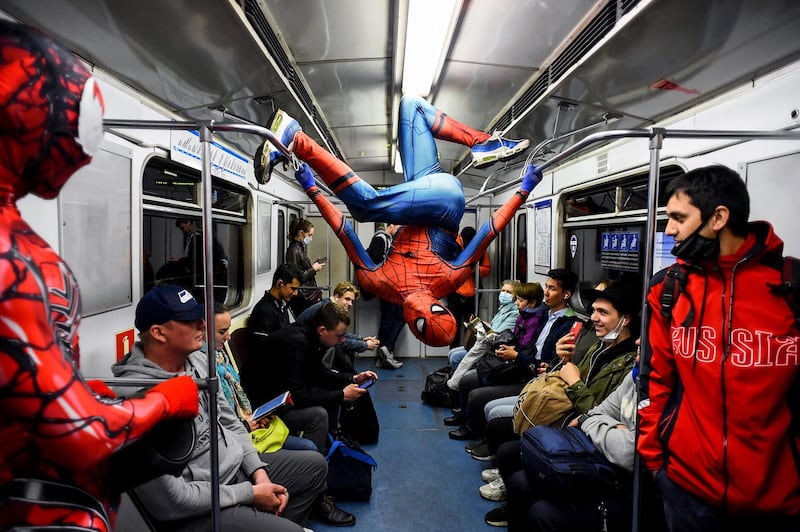 Dancers dressed in Spider-Man costumes perform for passengers on the Saint Petersburg subway, in Russia. AFP