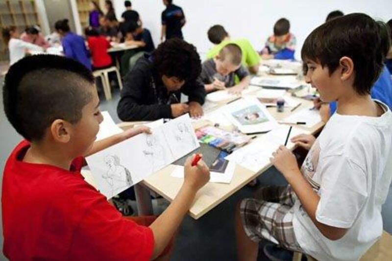 Children take part in a comic drawing workshop at Manarat Al Saadiyat in Abu Dhabi. The workshop's aim was to discover the links that exist between the art in Birth of a Museum and comic strips. Christopher Pike / The National