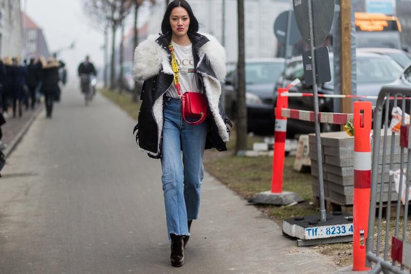 Tiffany Hsu wearing the Gucci T-shirt with loose jeans and a bright cross-body bag at Copenhagen Fashion Week. Christian Vierig/Getty Images