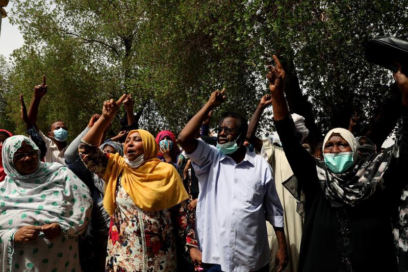 Supporters of ousted former Sudanese President Omar al-Bashir shout slogans the moment Omar al-Bashir and his companions arrived at the courtroom in Khartoum, Sudan.  EPA