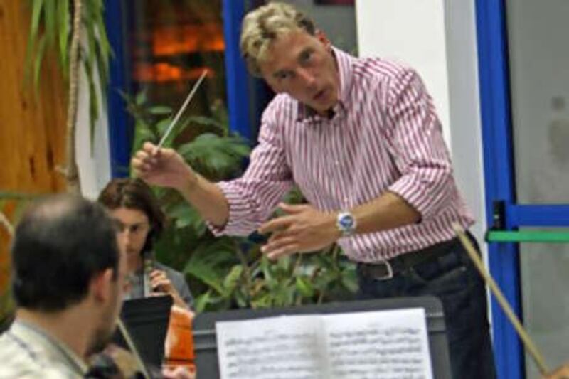 Philipp Maier conducts the UAE Philharmonic Orchestra during a recent summer rehearsal session.