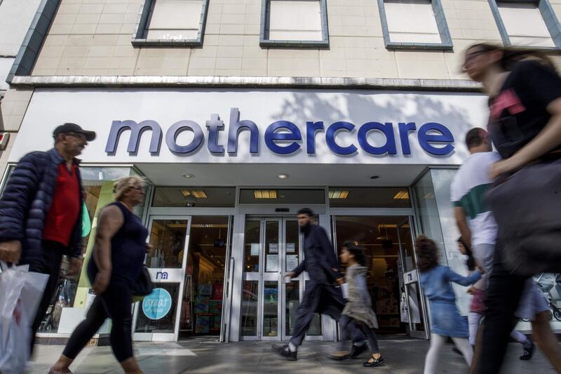 (FILES) In this file photo taken on June 19, 2018 Shoppers walk past a Mothercare shop on Wood Green High Street in north London on June 19, 2018. Britain's baby products retailer Mothercare said on November 4, 2019 it was putting its loss-making UK business into administration at a risk of more than 2,000 jobs. / AFP / Tolga Akmen
